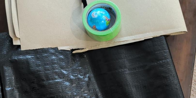 Items in the bag.   1. Small Globe  2. One strip of Velcro  3. Brown paper  4. Duct tape  5. Plastic Sheet 
