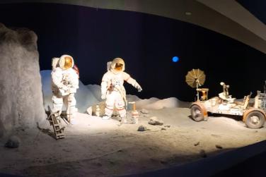 Astronaut and Moon rover on the surface of moon 