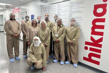 People fully clothed in special clothes in a pharmaceutical company