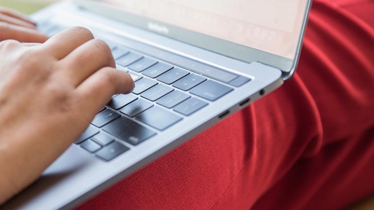 Typing on a laptop