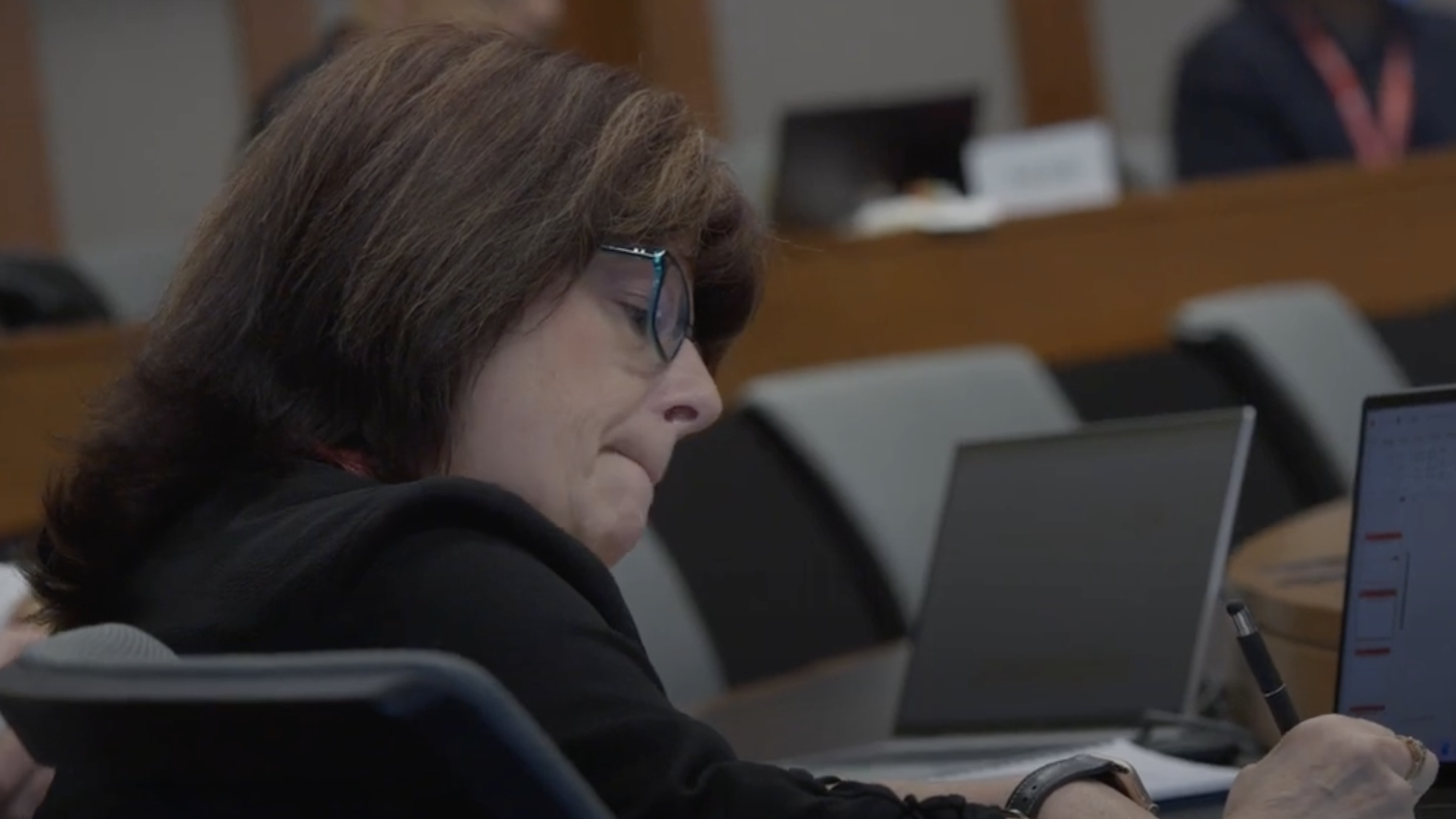 Side profile of a woman's face sitting in a classroom