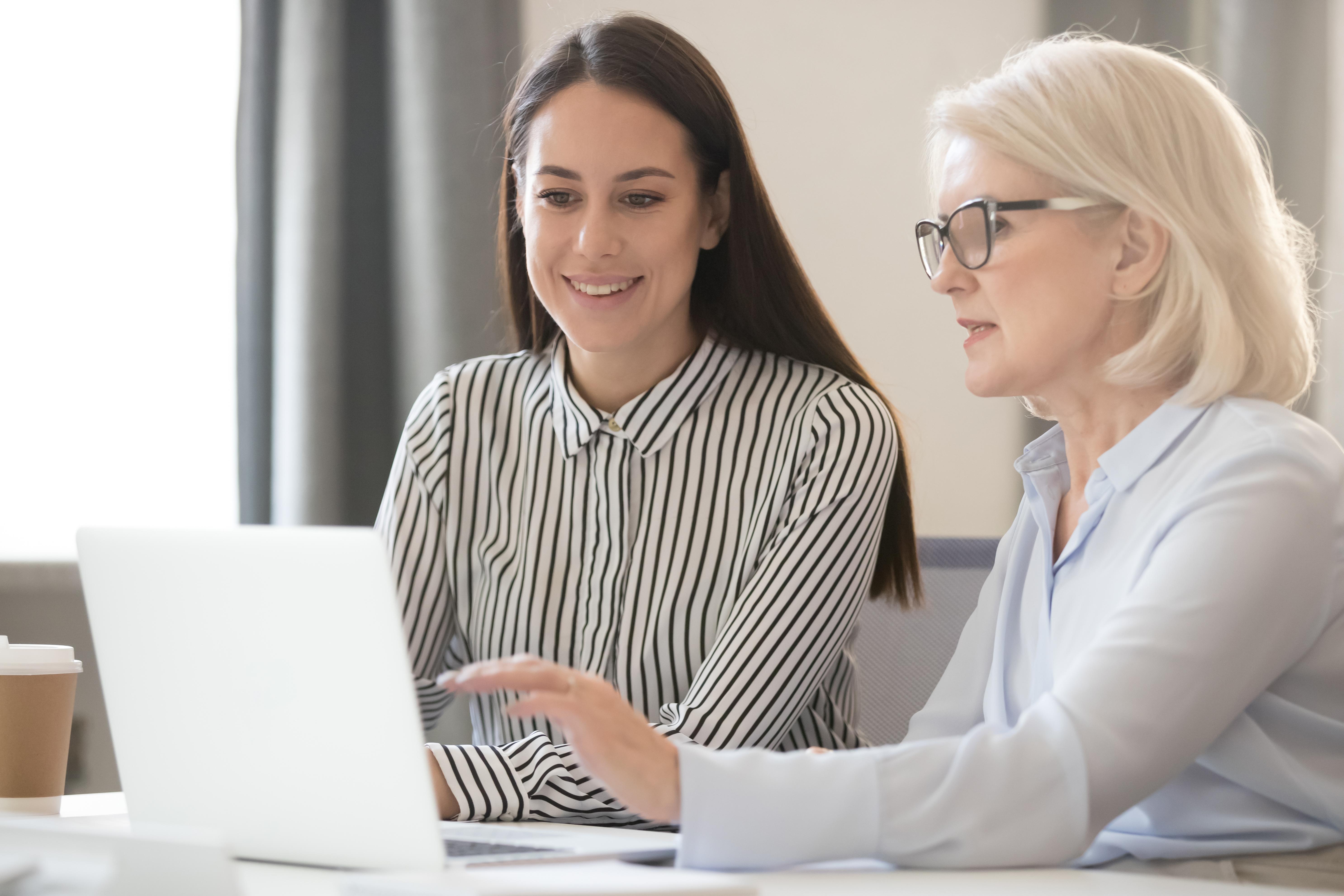Two women looking at a computer 