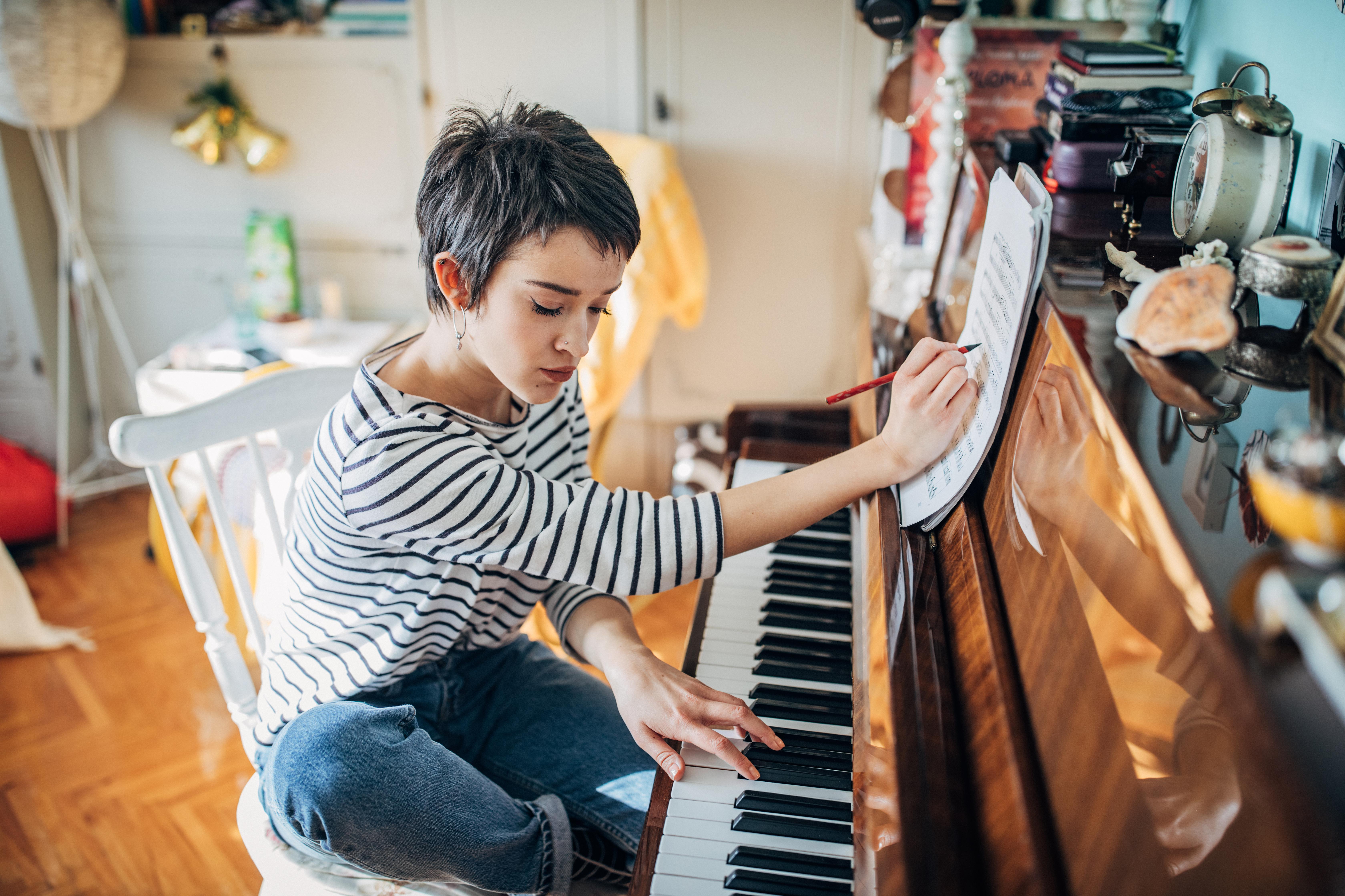 Woman at piano composing music