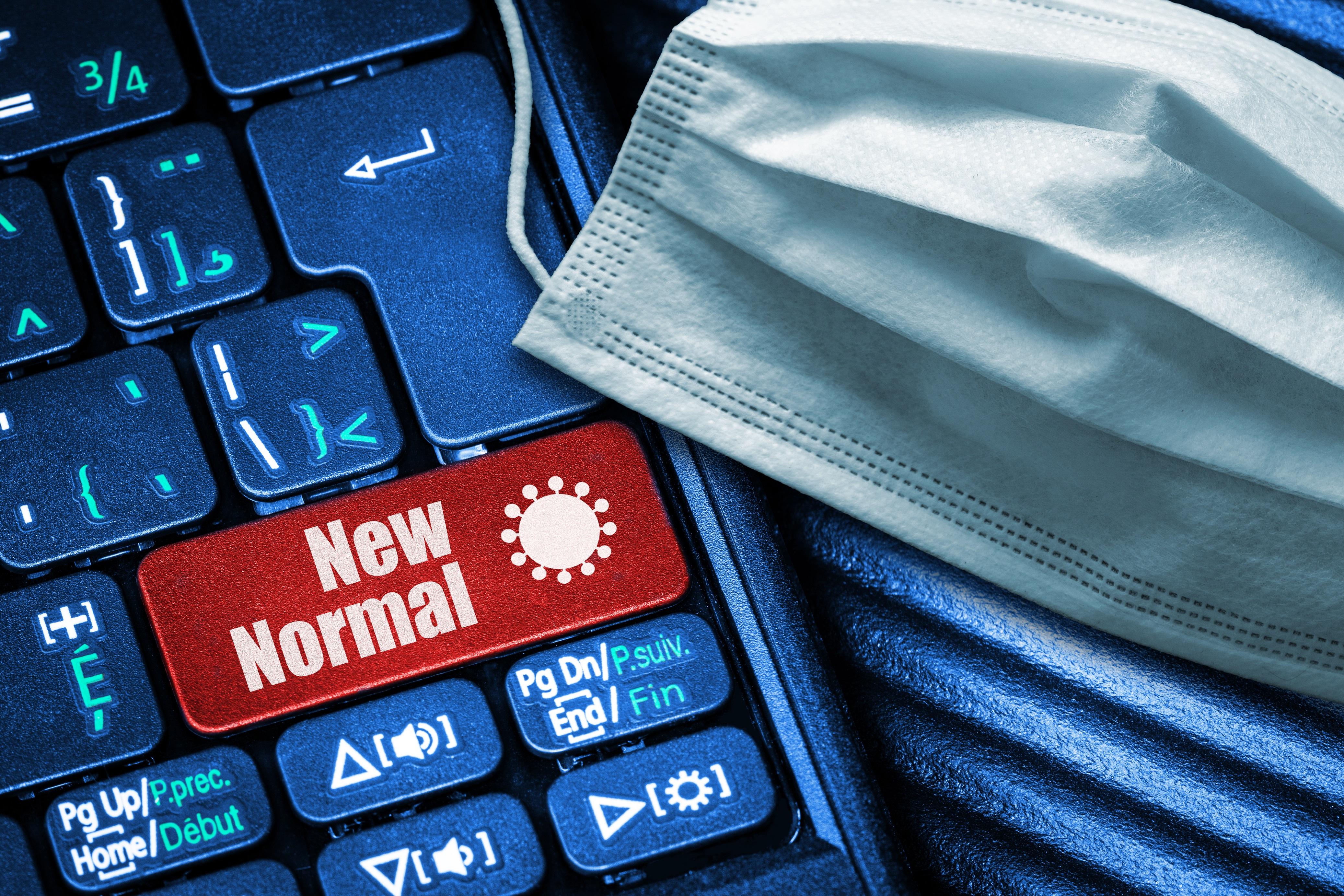 keyboard with mask and a "new normal" button on it 