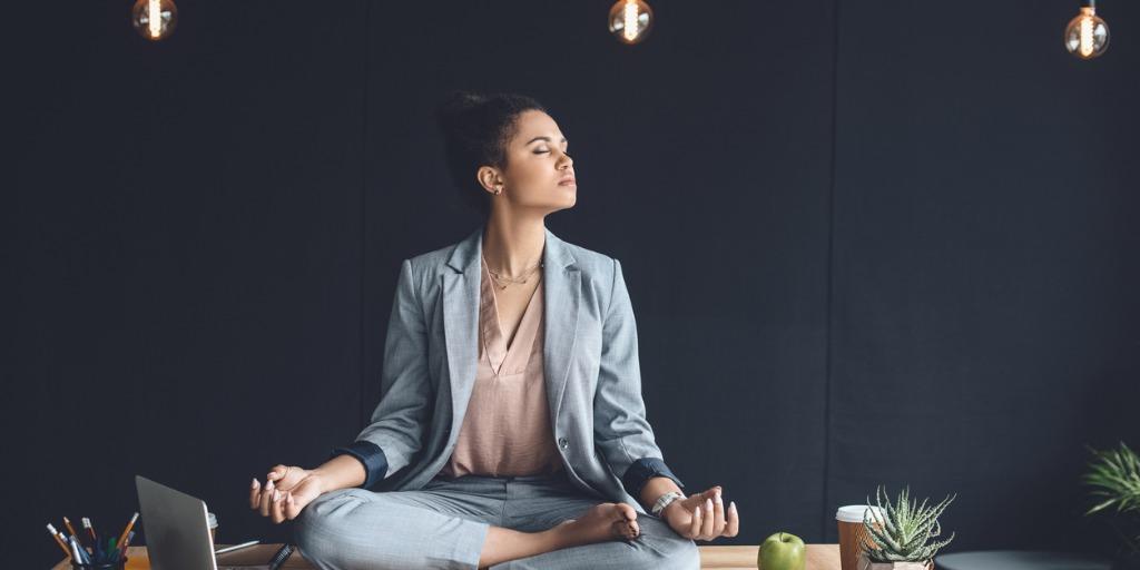 Female leader meditating in office