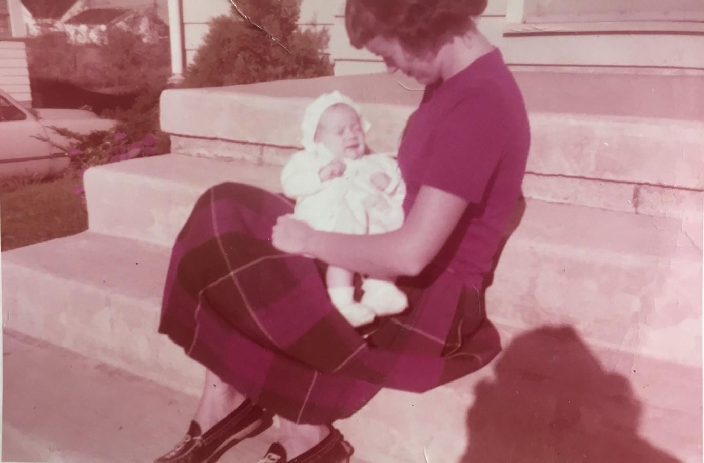 A photo from the 1950s of a woman holding her baby 