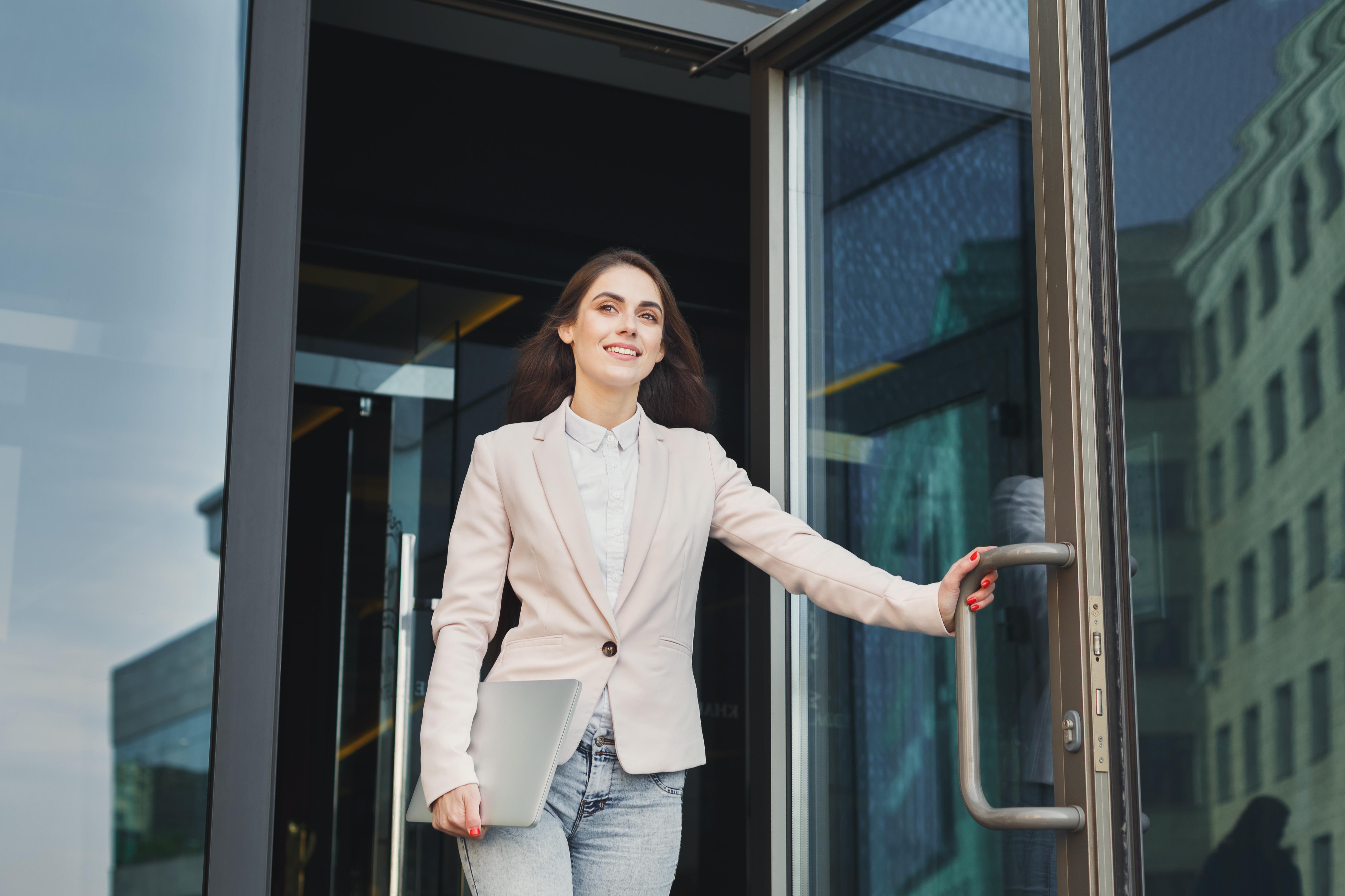 Woman walking happily out of the office 