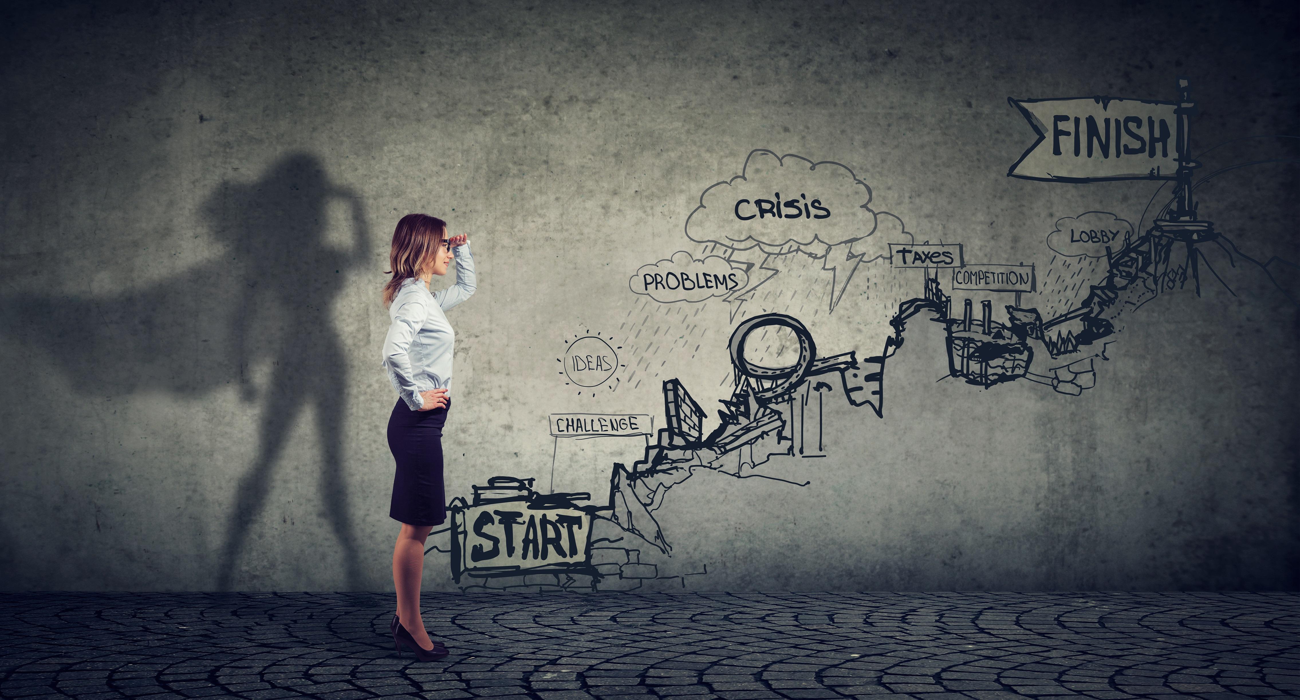 Artistic depiction of a businesswoman facing challenges. Her shadow is that of a superhero. 