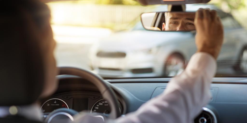 leader looking into the rear-view mirror