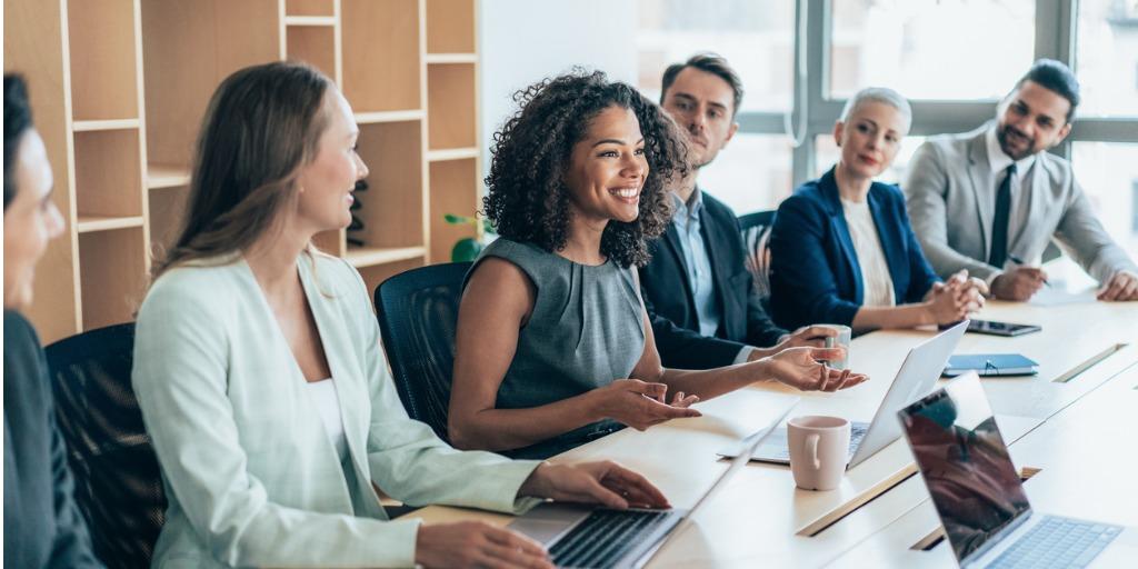 Multiethnic group of businesspeople sitting together and having a meeting in the office.
