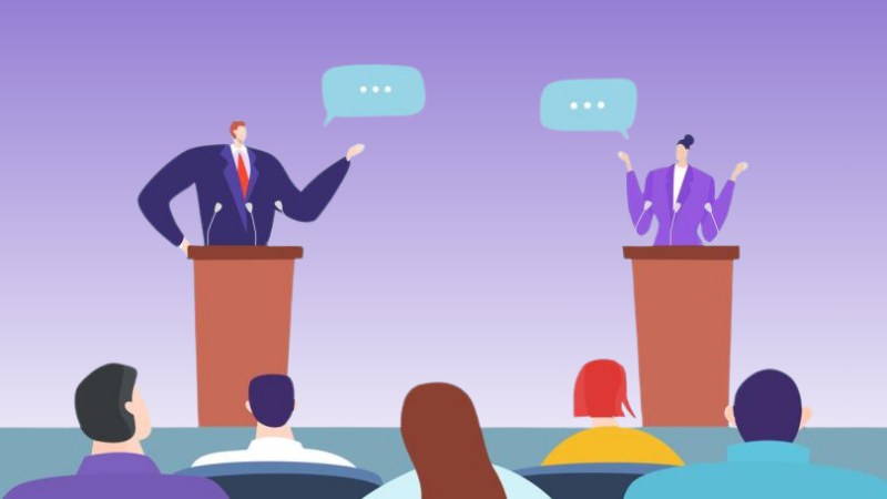 Two political figures having a debate in front of an audience