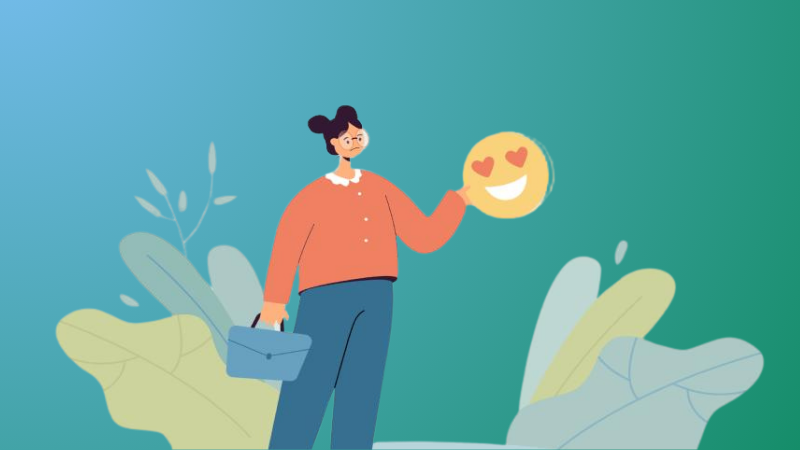 Sad woman holding a smiling emoticon