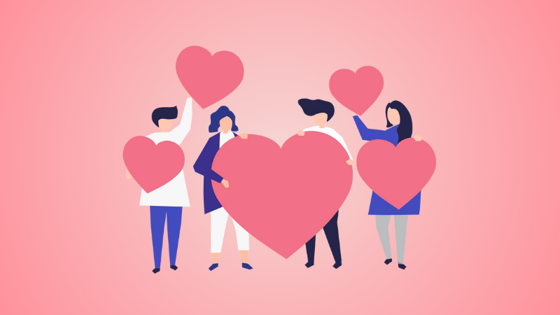 4 employees holding love hearts