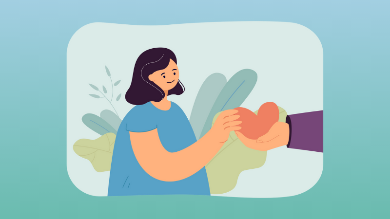 Hand giving red heart gift to girl