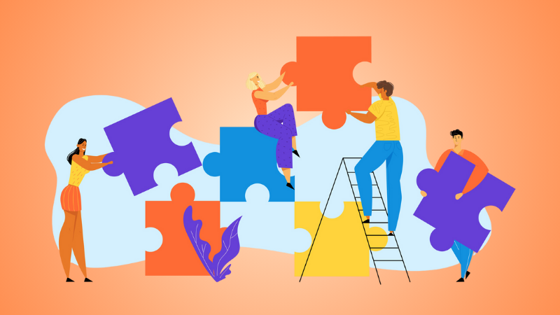 group of people putting a puzzle together 