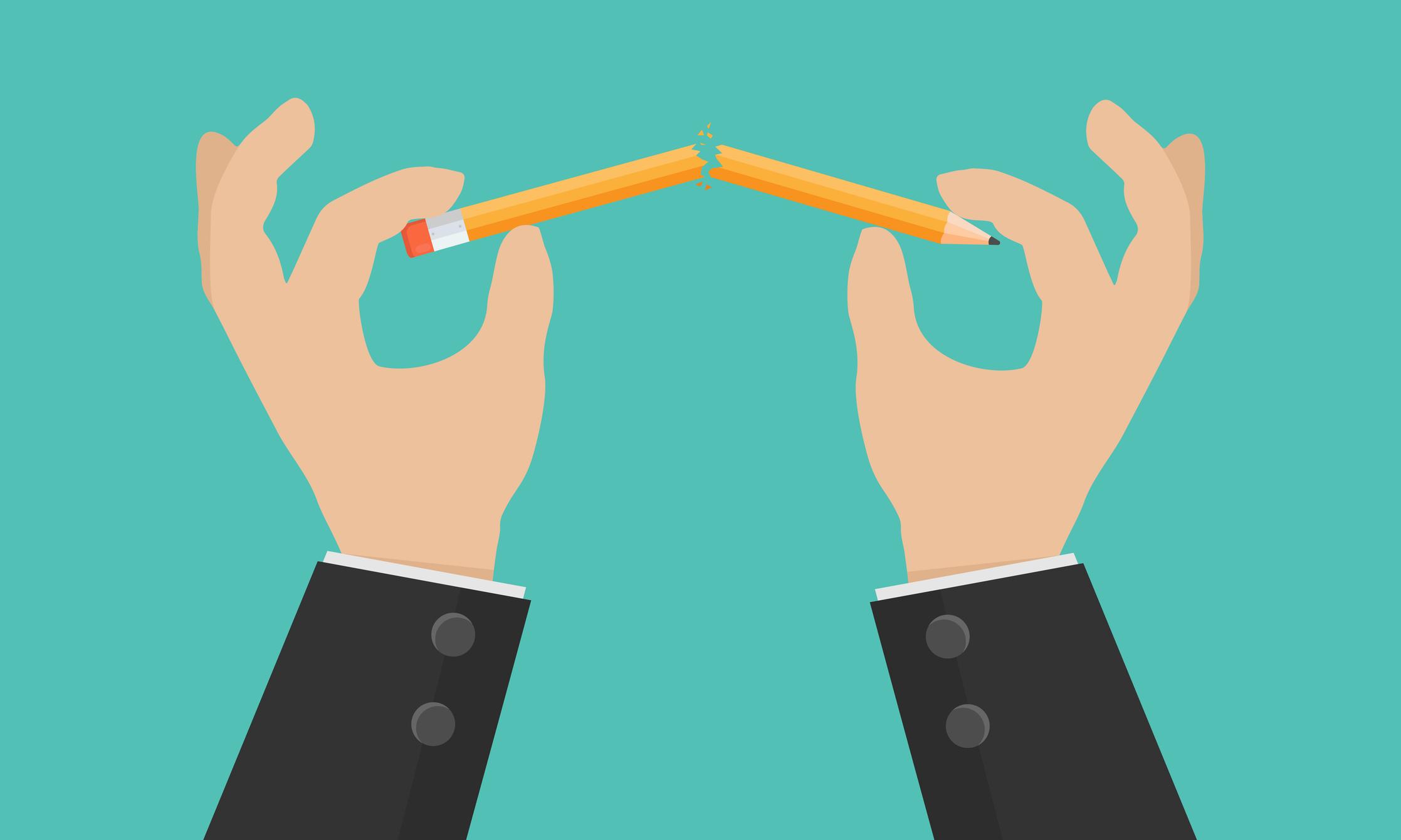 a person breaking a pencil in half