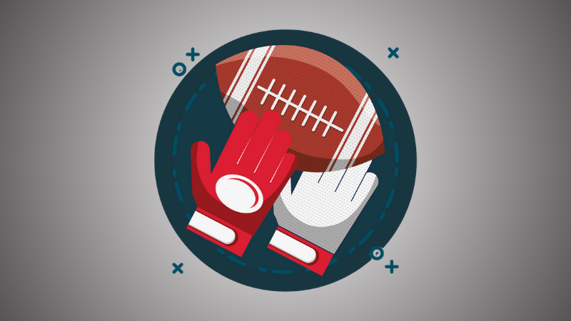 red gloves holding an American football