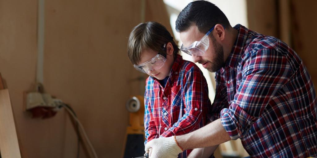 Mentor shows a young apprentice how to use a tool safely