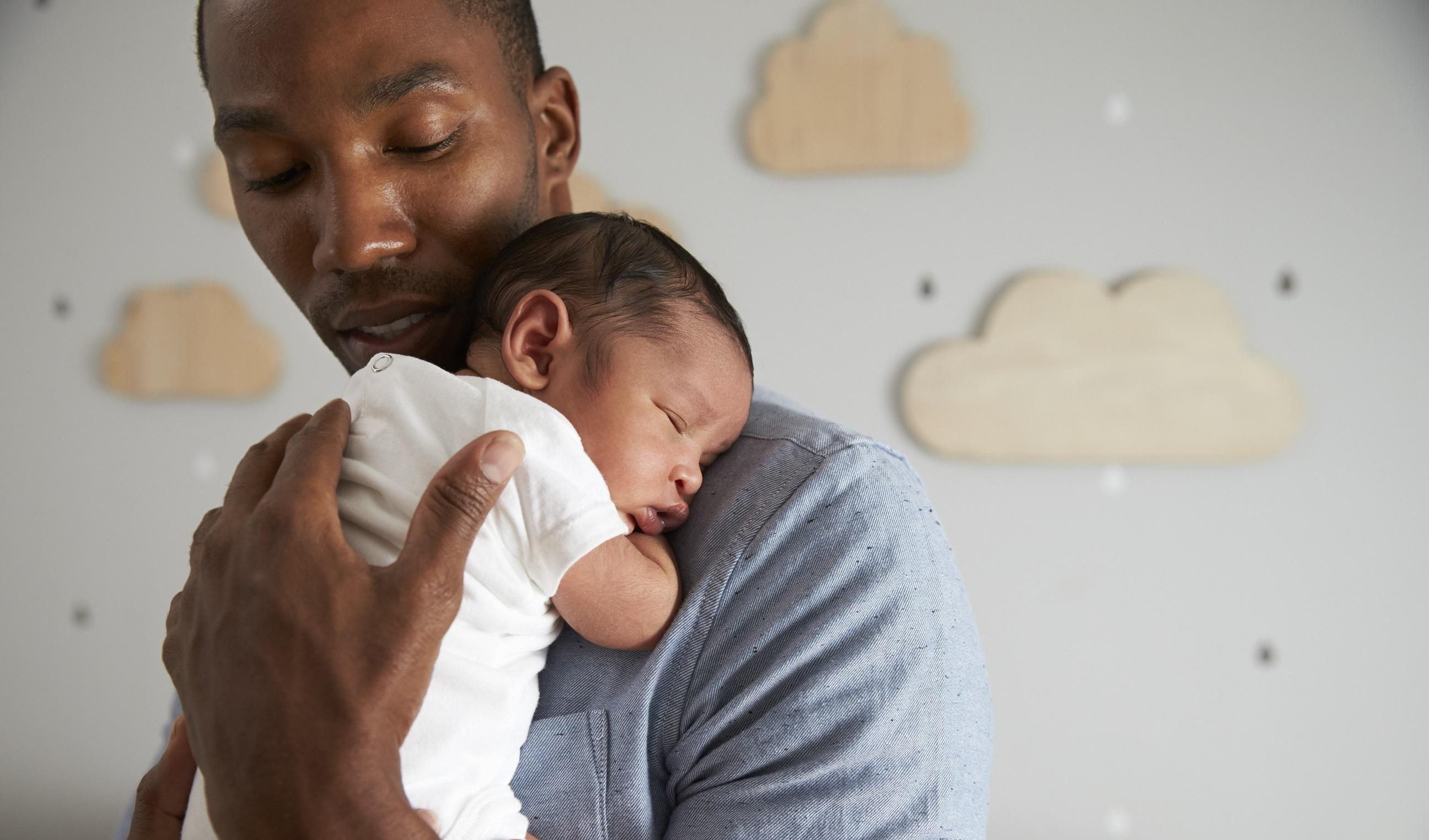 Dad holds sleeping baby