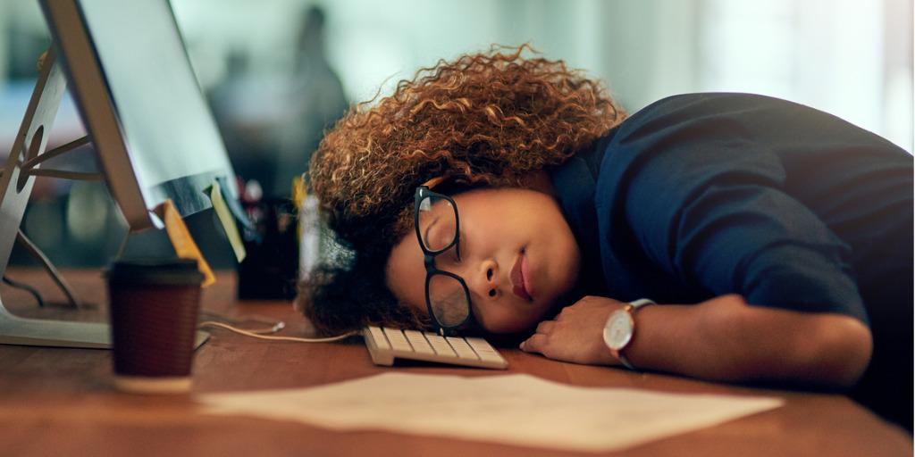 Women falling asleep at work desk
