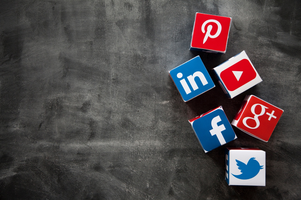 cubes with different social media logos on them (Facebook, Google, Twitter, Pinterest, etc.)