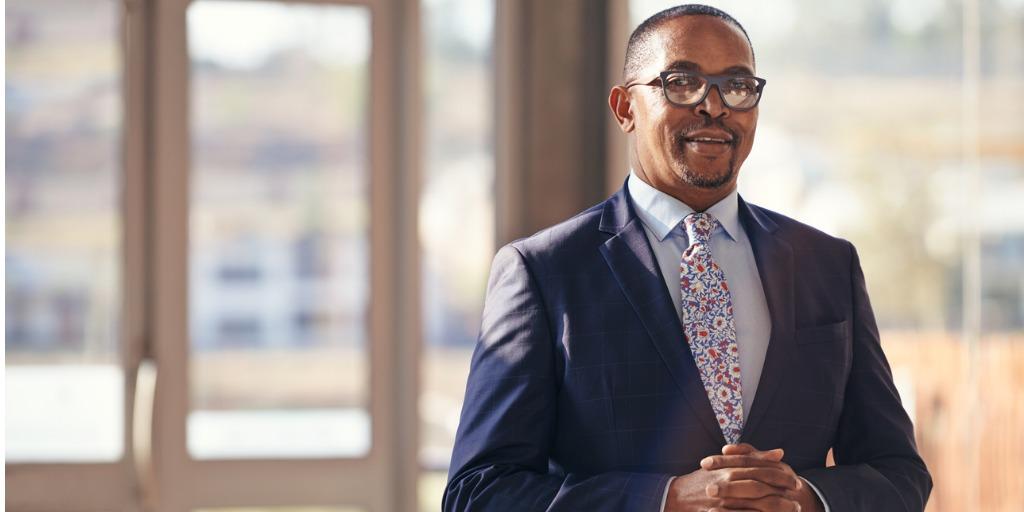 Man standing in front of windows