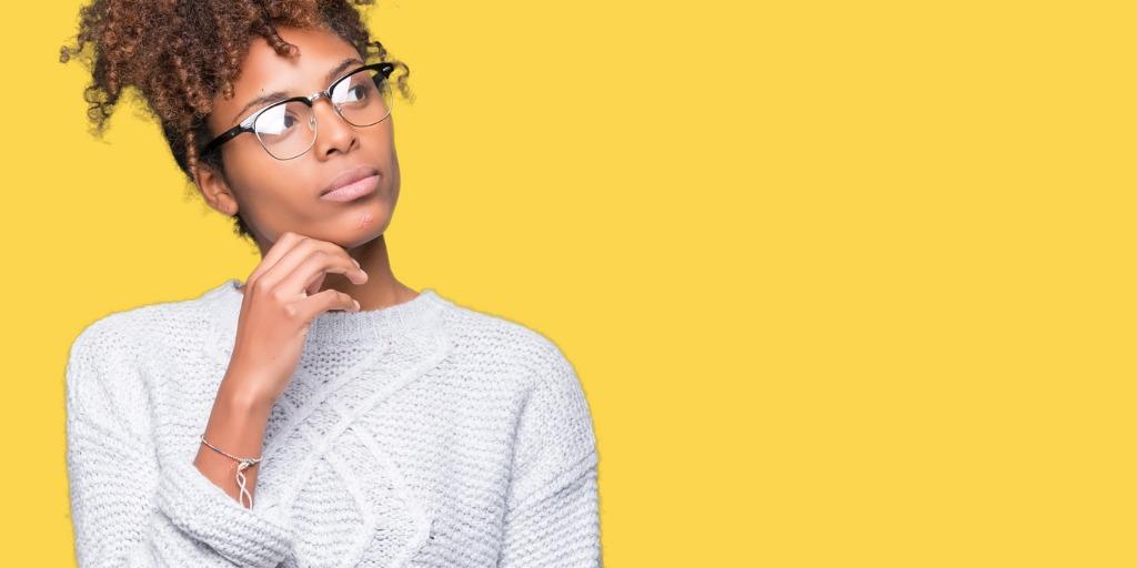 Woman thinking with hand on chin