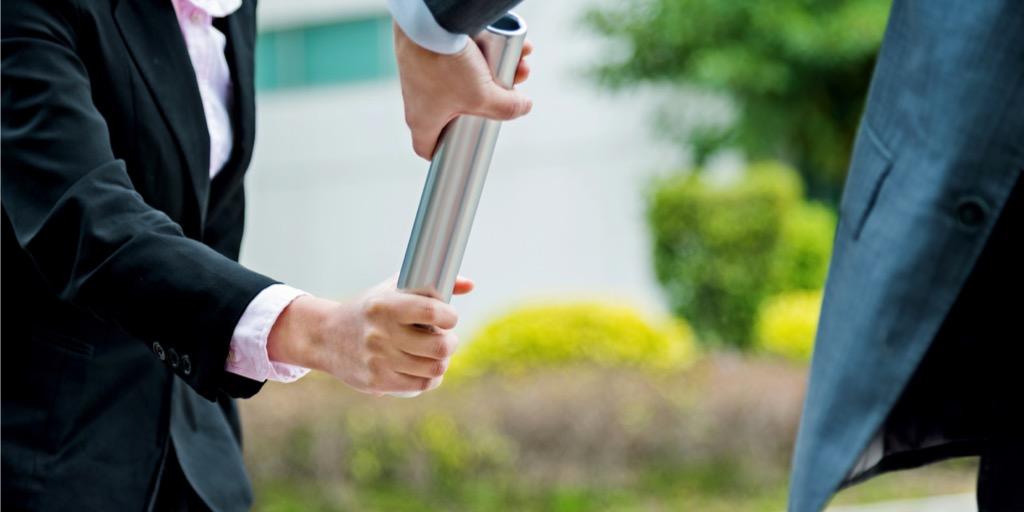 Businesspeople passing relay baton