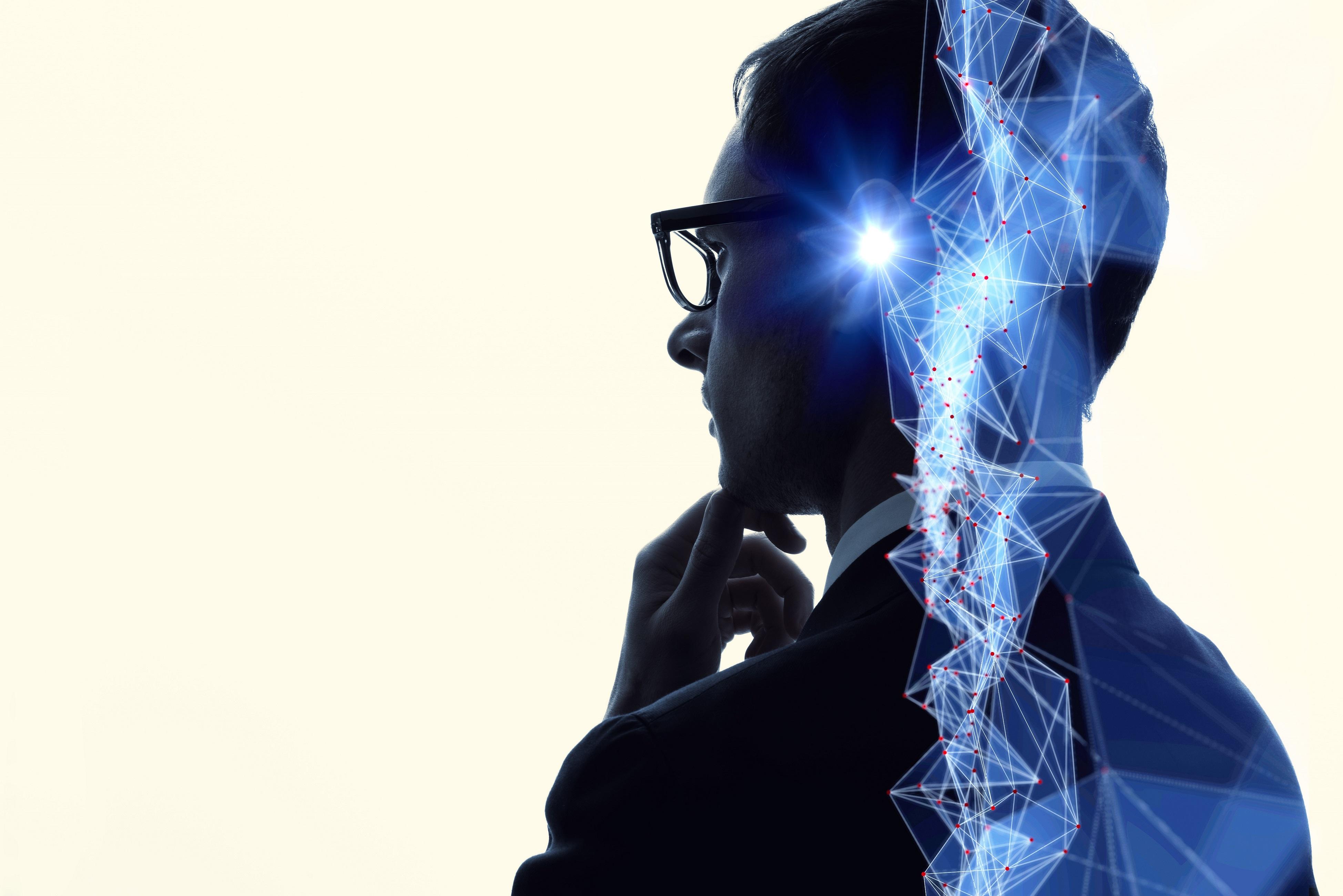 Man thinking with blue light glowing in his head 