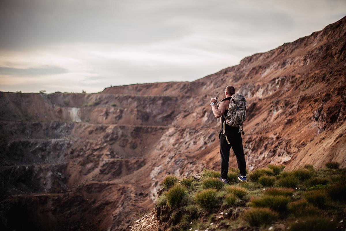 A man standing on the side of mountain