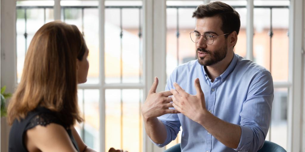 leader in eyeglasses explaining project details