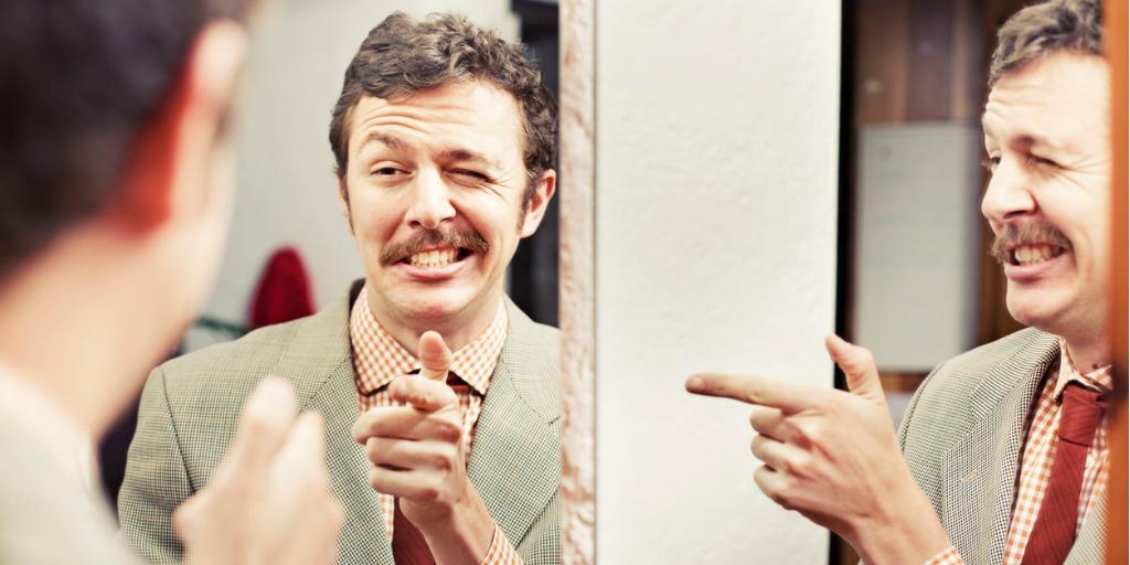 A man is looking at himself in the mirror