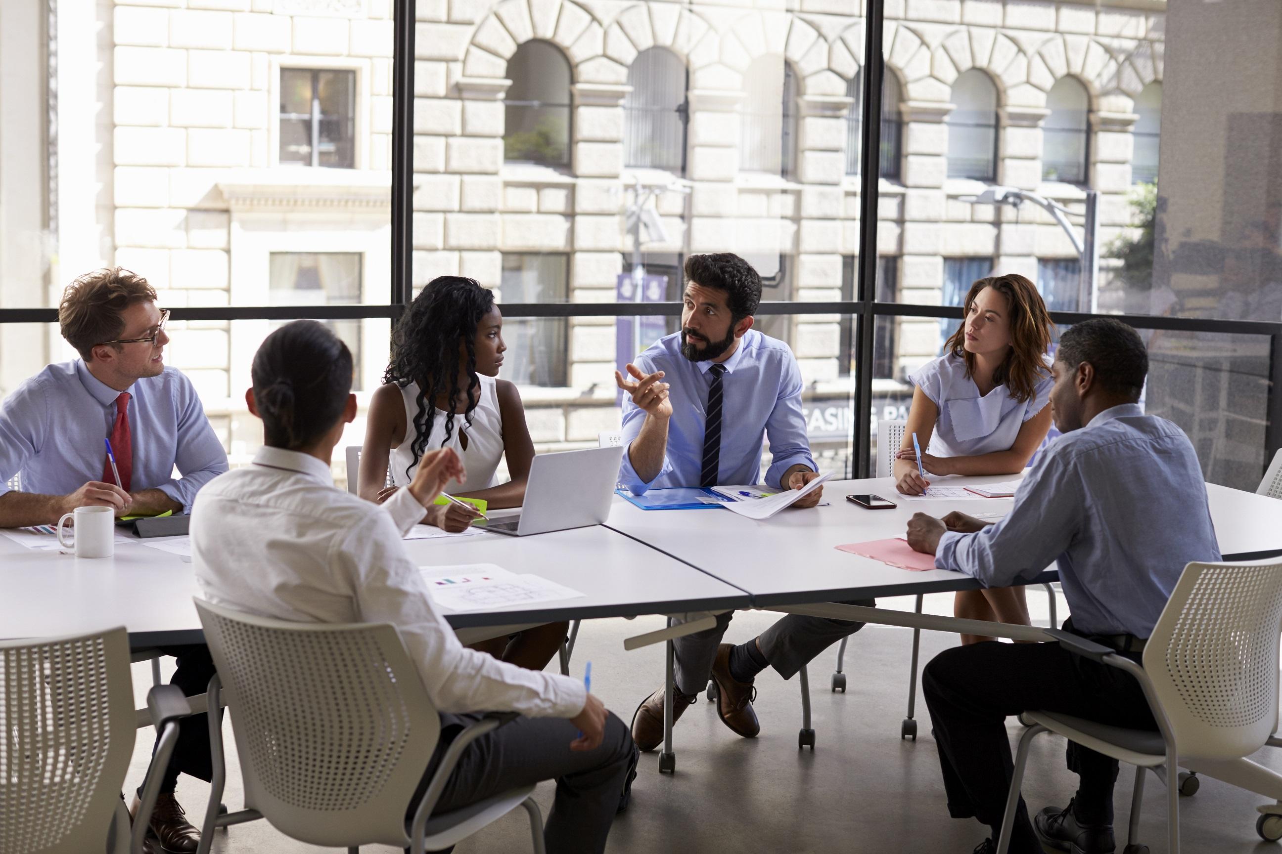 group of employees sitting in a circle having a meeting