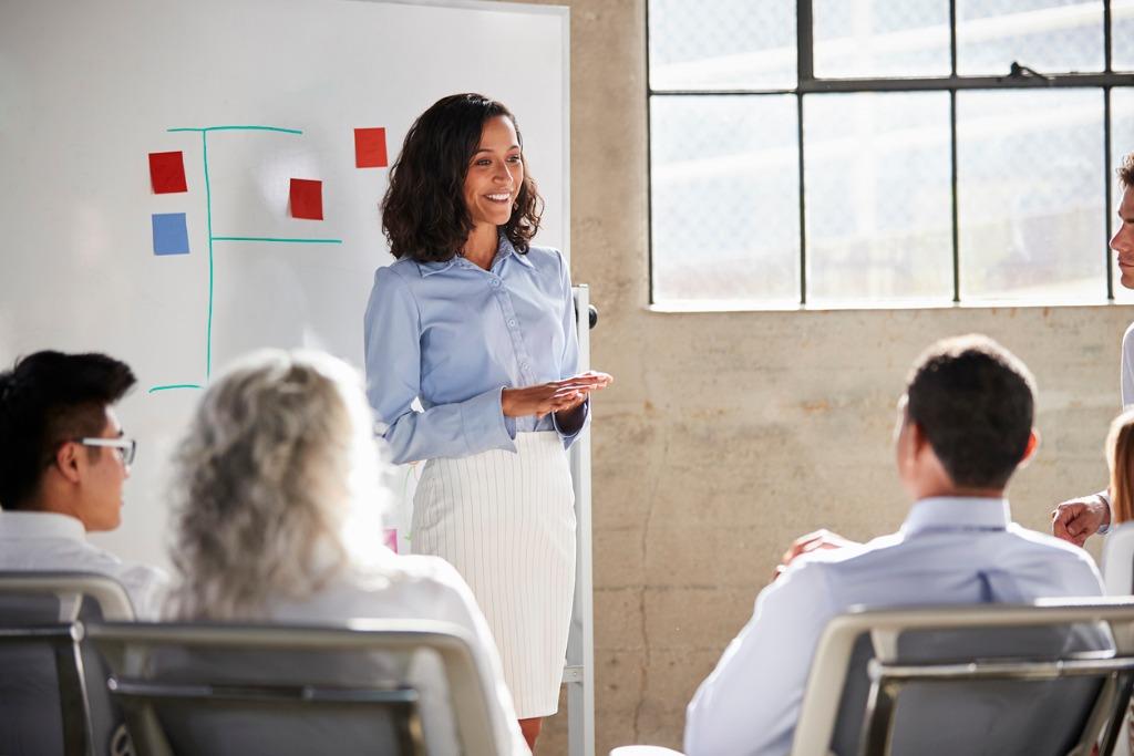 business woman giving a presentation at a meeting room 