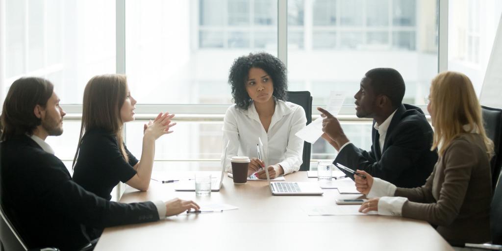 Diverse group of people sitting at conference table