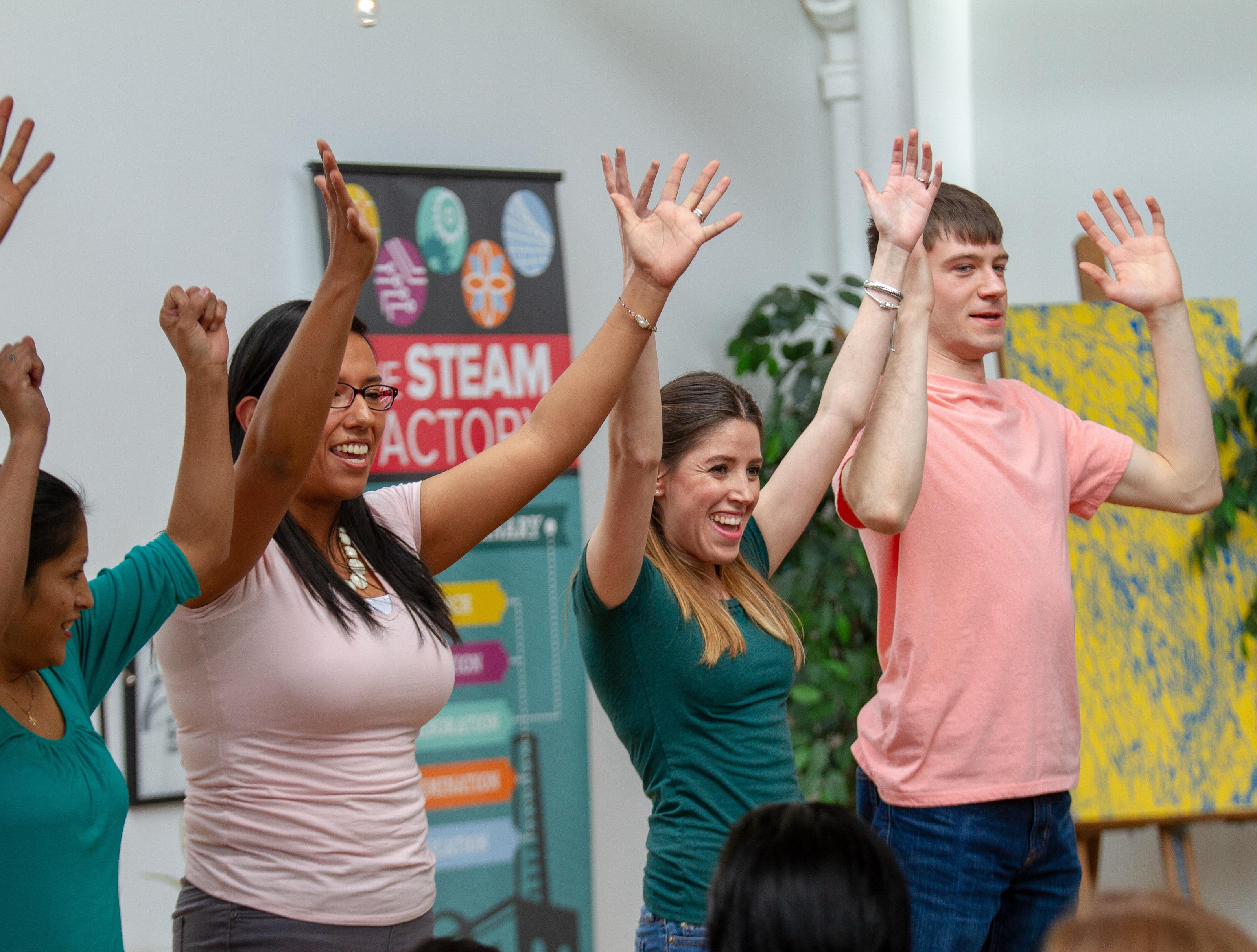 Some employees are volunteering raising hands together