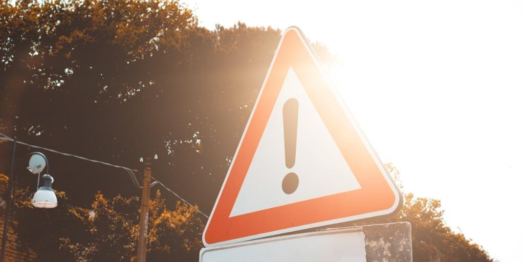 triangular road sign with exclamation point on it signifying "caution"