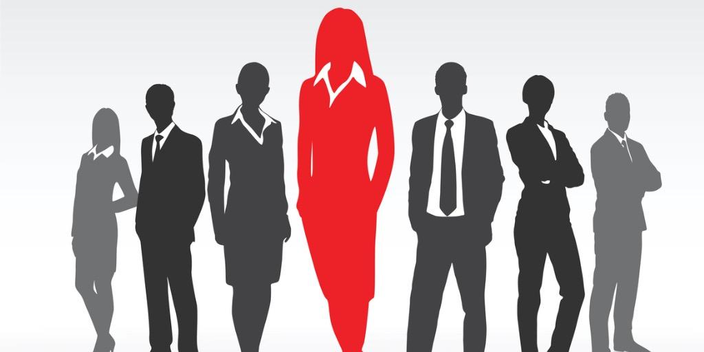 Red silhouette businesswomen with black and grey business people standing on either side 