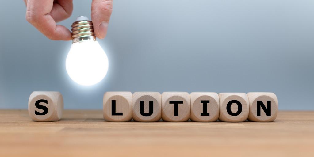 Lettered dice spelling out the word "solution"