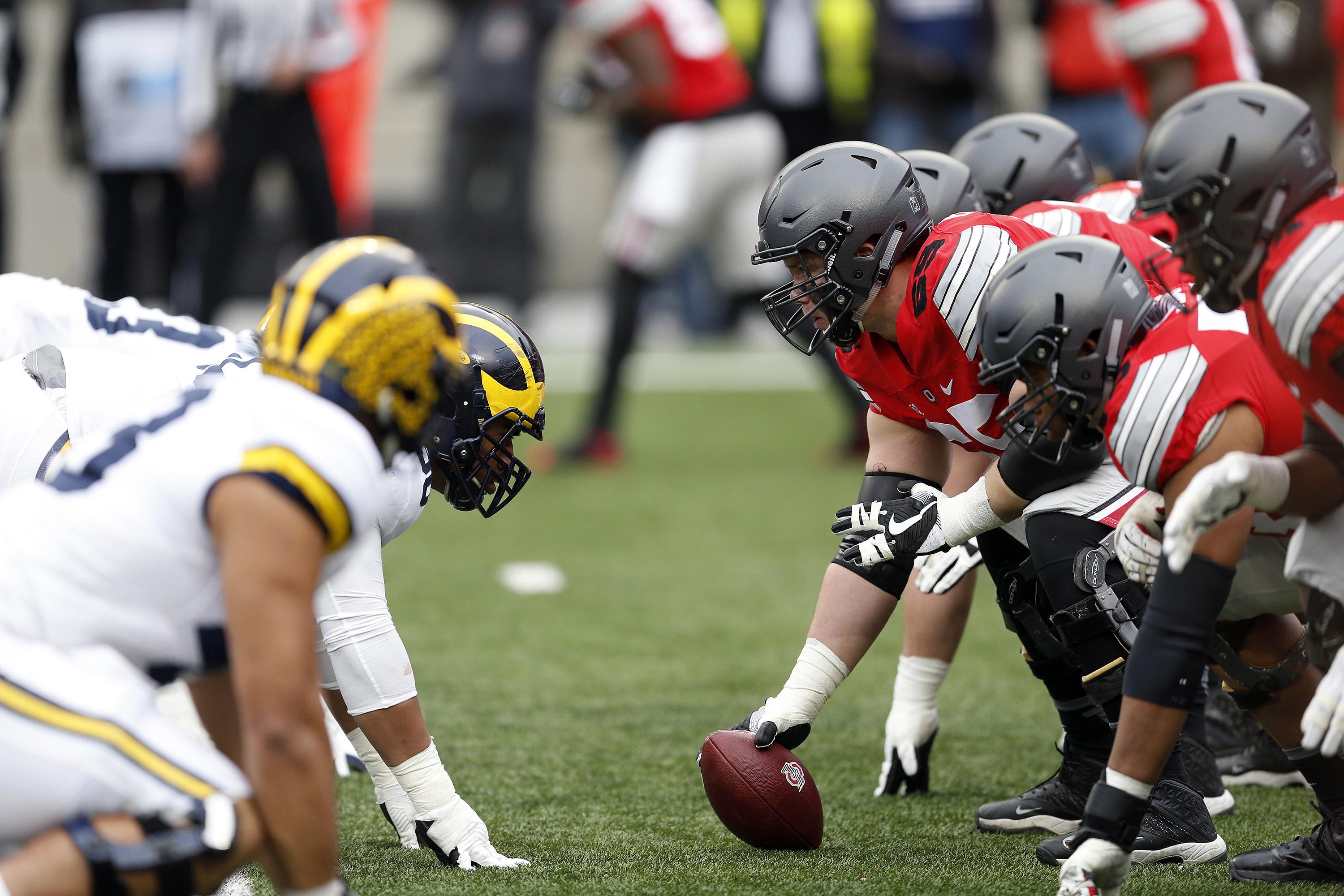 the Ohio State Buckeyes and the Michigan Wolverines line up for the next play