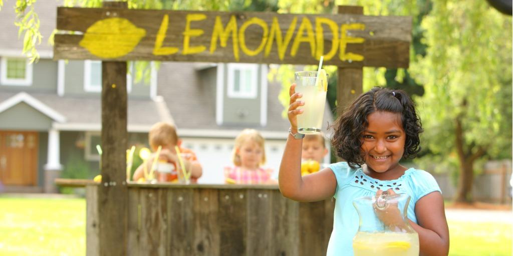 One young girl selling lemonade on the street