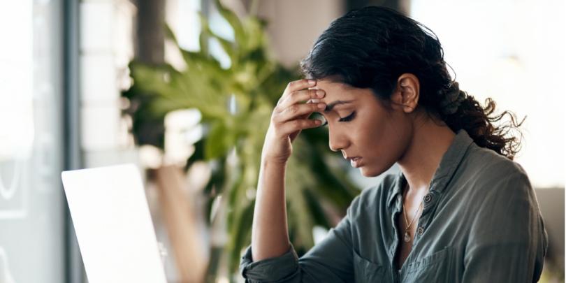 a young woman experiencing stress while working in a cafe