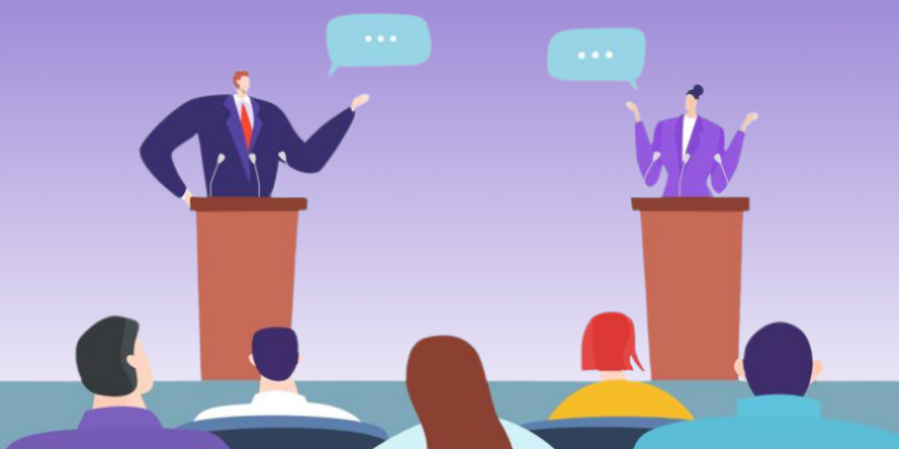 Two political figures having a debate in front of an audience