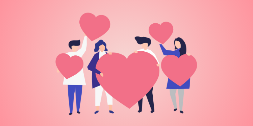 4 employees holding love hearts