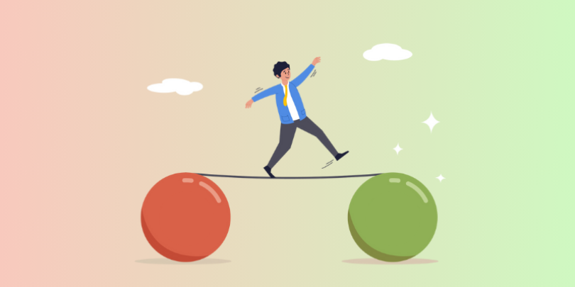 balancing on a stick that is supported by red and green balls