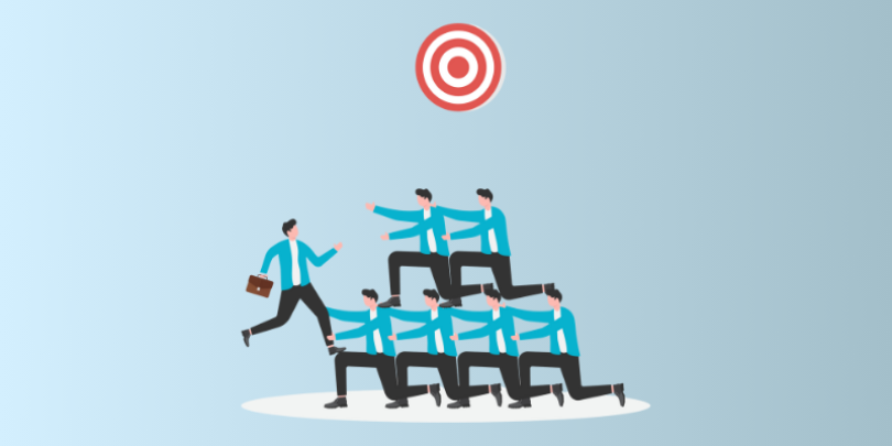 employees helping each other climb to reach a target