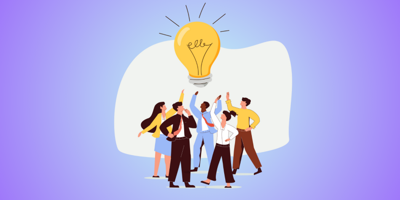 group of employees reaching for a lightbulb