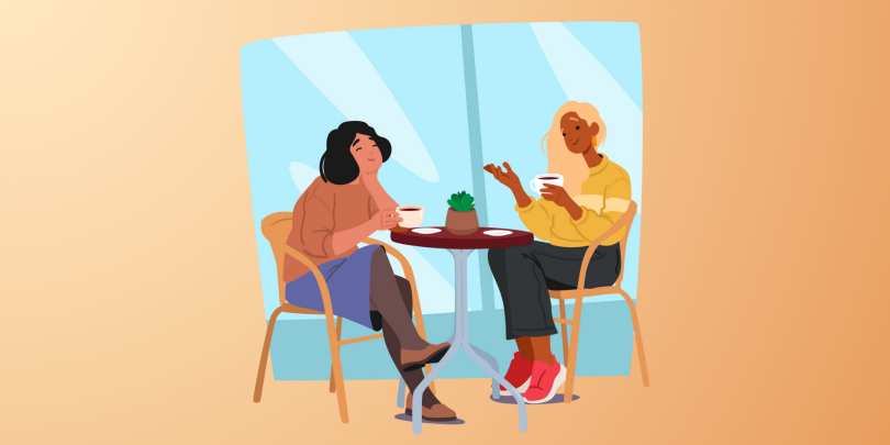 2 women chatting at a table