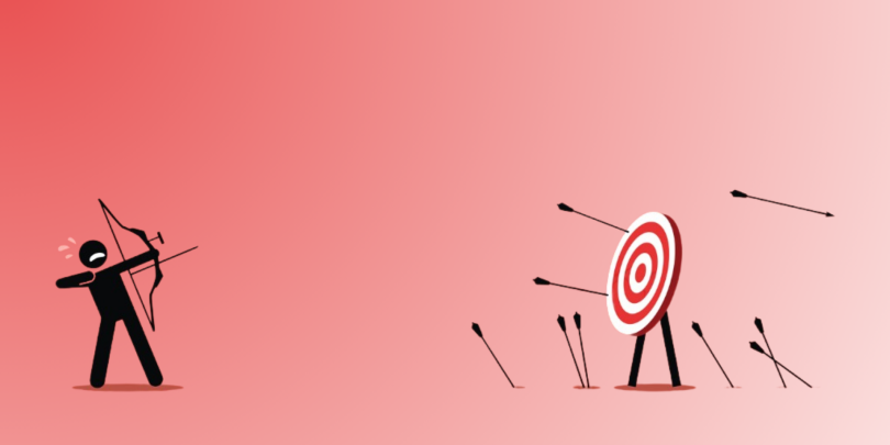 Person practicing shooting arrows at target; missing more than hitting the target