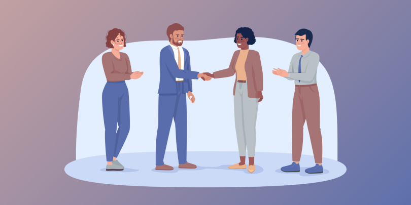 4 employees smiling and shaking hands with each other